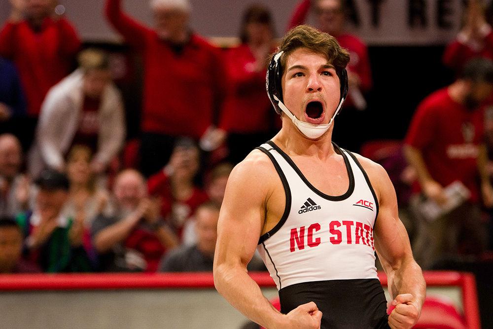 Redshirt freshman Jarrett Trombley celebrates after pinning his opponent on Friday, Feb. 14, 2020 at Reynolds Coliseum. NC State beat Virginia Tech with a final score of 21-18.