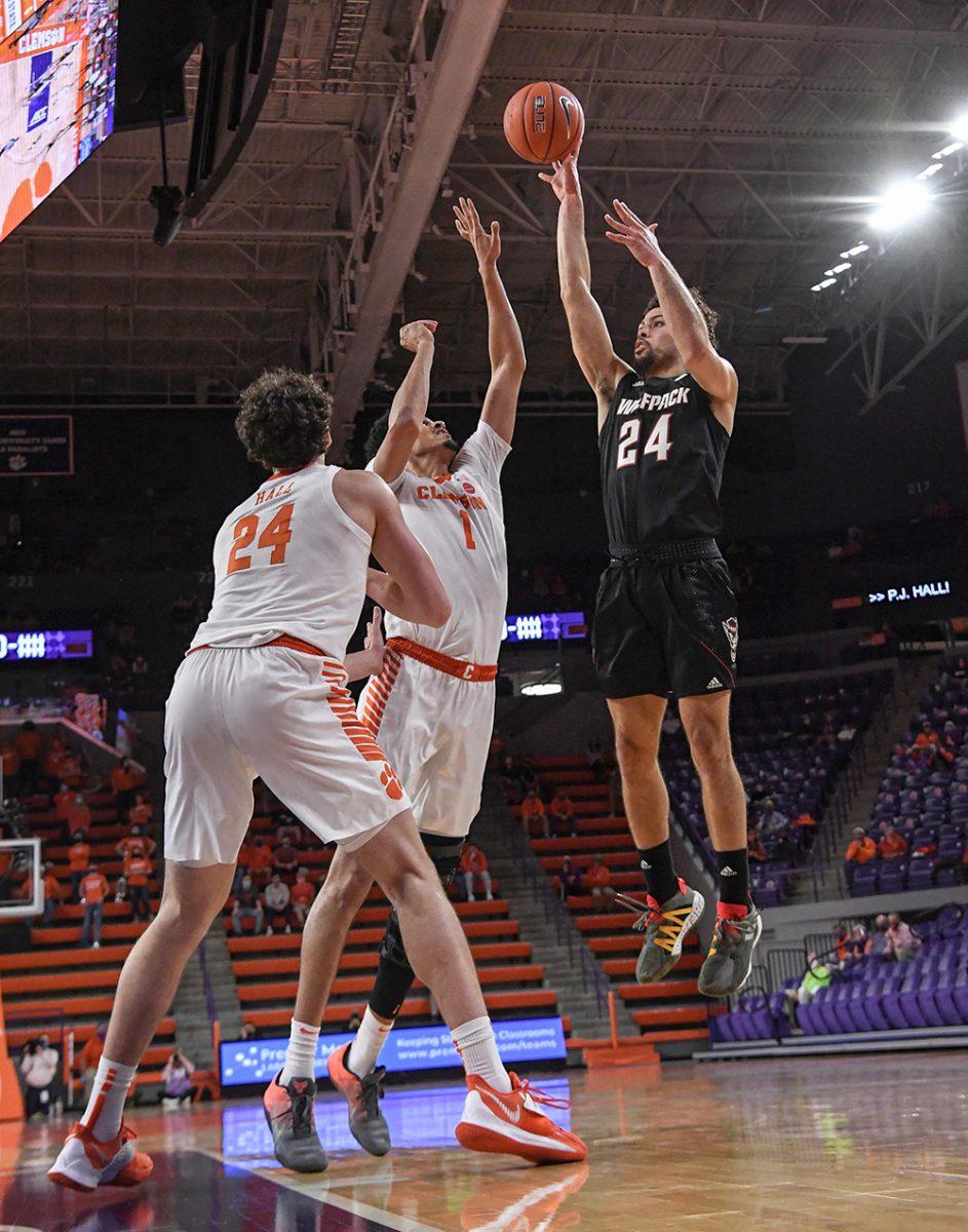 NC State guard Devon Daniels(24) shoots near Clemson senior forward Jonathan Baehre(1) and Clemson freshman forward PJ Hall(24) during the first half Jan 5, 2021; Clemson, South Carolina, USA; at Littlejohn Coliseum. Mandatory Credit: Ken Ruinard-USA TODAY Sports