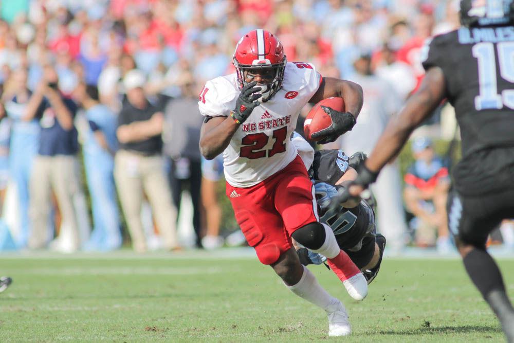 Senior running back Matt Dayes runs up the field during the 28-21 win over UNC-Chapel Hill in Kenan Stadium on Friday.