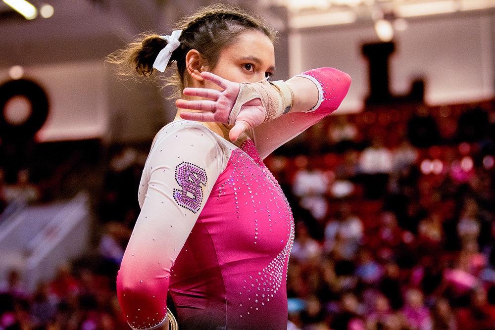 Freshman Chloe Negrete hits a pose during her Floor performance on Saturday, Feb. 15 at Reynolds Coliseum. Negrete tied for third in the Floor results with a score 9.900.
