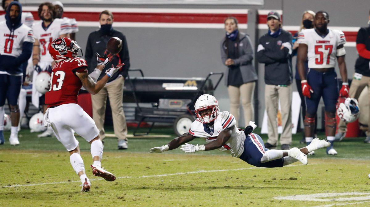 N.C. State cornerback Isaac Duffy (33) intercepts a pass intended for Liberty&#8217;s Shedro Louis (1) during the second half of N.C. State&#8217;s 15-14 victory over Liberty at Carter-Finley Stadium in Raleigh, N.C., Saturday, Nov. 21, 2020.