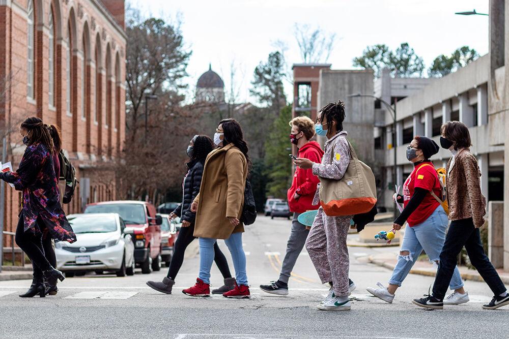 Protesters walk across Central Campus during the Student Government organized Freeze Out Protest on Tuesday, Jan. 19, 2021. This march was in protest of the continued employment of Chadwick Seagraves, an NC State employee with alleged ties to the white nationalist group Proud Boys.