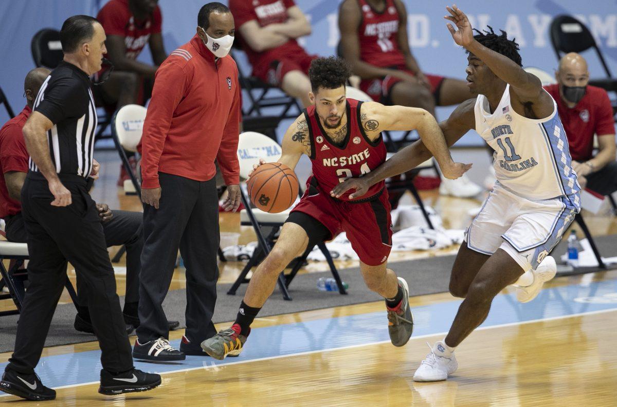 North Carolina's Day&#8217;Ron Sharpe (11) defends N.C. State's Devon Daniels (24) in the second half on Saturday, January 23, 2021 at the Smith Center in Chapel Hill, NC.