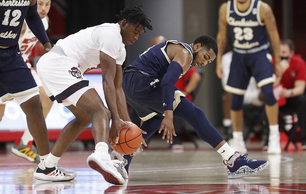 N.C. State's Cam Hayes (3) steals the ball from Charleston Southern's Travis Anderson (0) during the first half of N.C. State&#8217;s game against Charleston Southern in the Wolfpack Invitational at Reynolds Coliseum in Raleigh, N.C., Wednesday, Nov. 25, 2020.