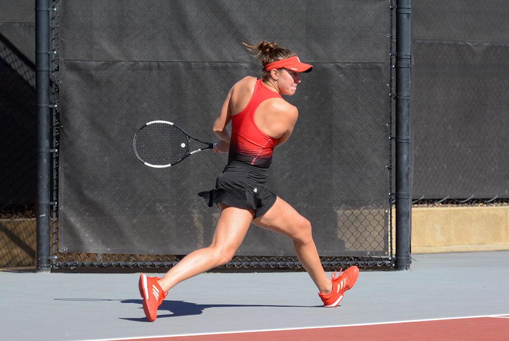 Fourth year Adriana Reami returns the serve against Virginia on Sunday, March 1, 2020 at J.W. Isenhour Tennis Center. Reami and Daniel lost their doubles match to Virginia 3-6.