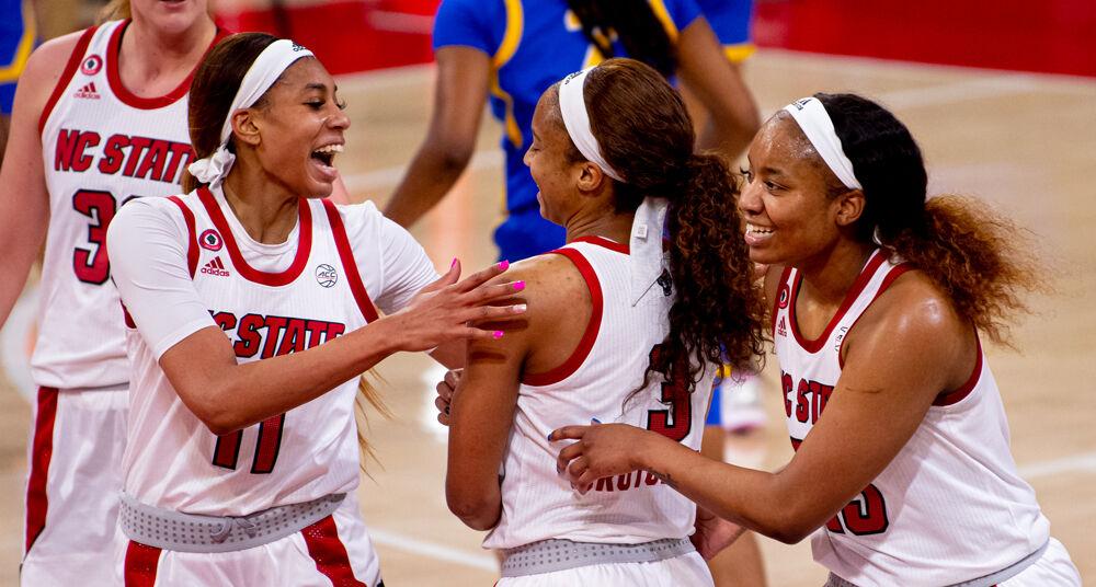 Sophomore wing Jakia Brown-Turner and senior forward Kayla Jones celebrate a basket by senior guard Kai Crutchfield on Thursday, Feb. 25, 2021 at Reynolds Coliseum. Crutchfield recorded 11 points and four steals as the Wolfpack beat Pittsburgh 83-53.
