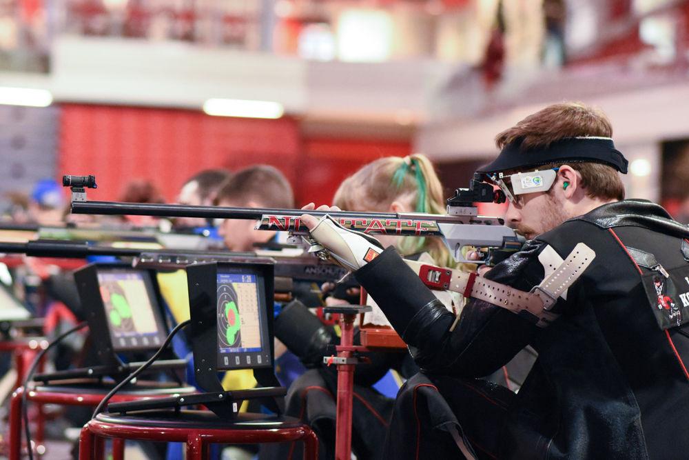 Senior shooter Lucas Kozeniesky takes aim at the target while in the kneeling position during the Wolfpack's meet against North Georgia on Jan 29. Kozeniesky marked perfect 100s in both series of the prone position to earn a 577 overall in the smallbore event of the 4657-4547 win at Reynolds Coliseum.