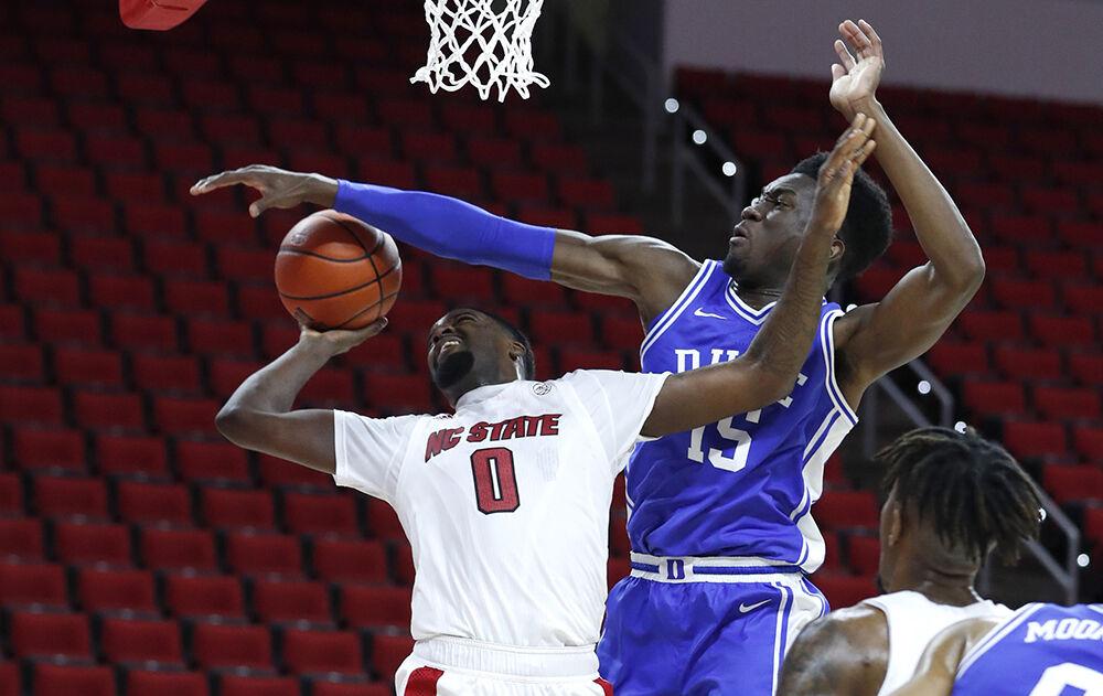 N.C. State's D.J. Funderburk (0) shoots as Duke&#8217;s Mark Williams (15) defends during the first half of N.C. State&#8217;s game against Duke at PNC Arena in Raleigh, N.C., Saturday, February 13, 2021.