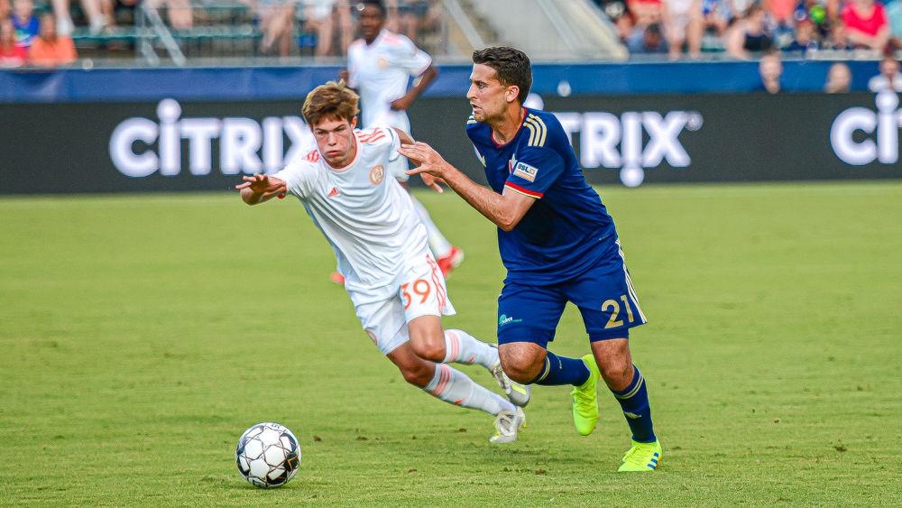 NCFC midfielder Nazmi Albadawi dribbles upfield against Atlanta United 2 midfielder Will Reilly on Saturday, July 27 at WakeMed Soccer Park. Albadawi assisted on one of NCFC&#8217;s goals in their 4-2 win. He also played for NC State men's soccer from 2010 to 2013.