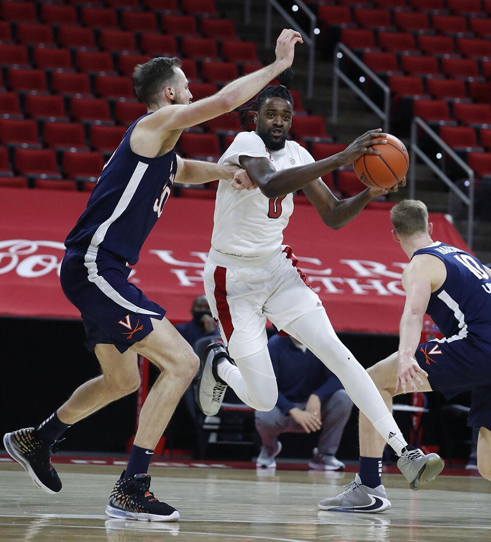N.C. State's D.J. Funderburk (0) tries to get around Virginia's Jay Huff (30) during the first half of N.C. State&#8217;s game against Virginia at PNC Arena in Raleigh, N.C., Wednesday, February 3, 2021.