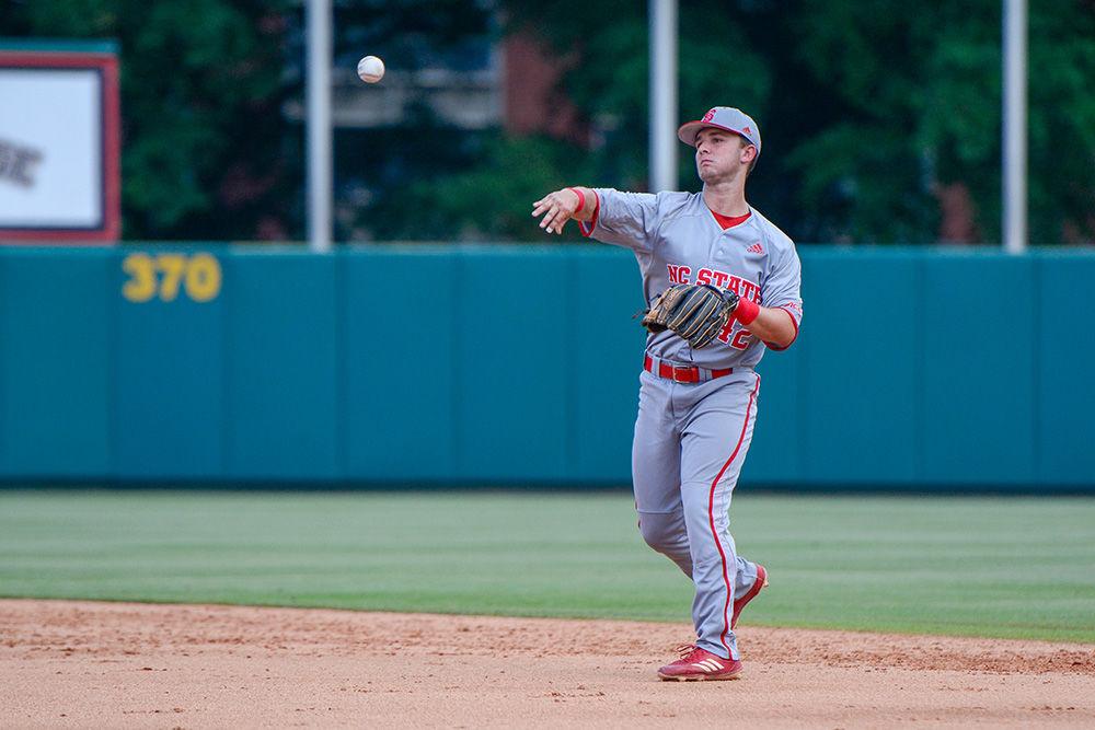 Freshman infielder J.T. Jarrett throws the ball towards the pitcher&#8217;s mound during the game versus Northeastern in Doak Field on Saturday. The Wolfpack beat Northeastern 9-3.