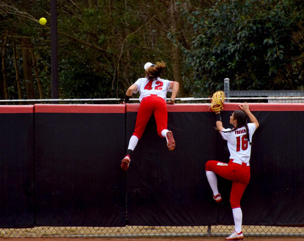 Redshirt senior outfielders Angie Rizzi and Tatyana Forbes watch a Virginia Tech home run sail over the outfield wall on Sunday, March 14, 2021 at Dail Softball Stadium. The Wolfpack 17-4 after five innings.