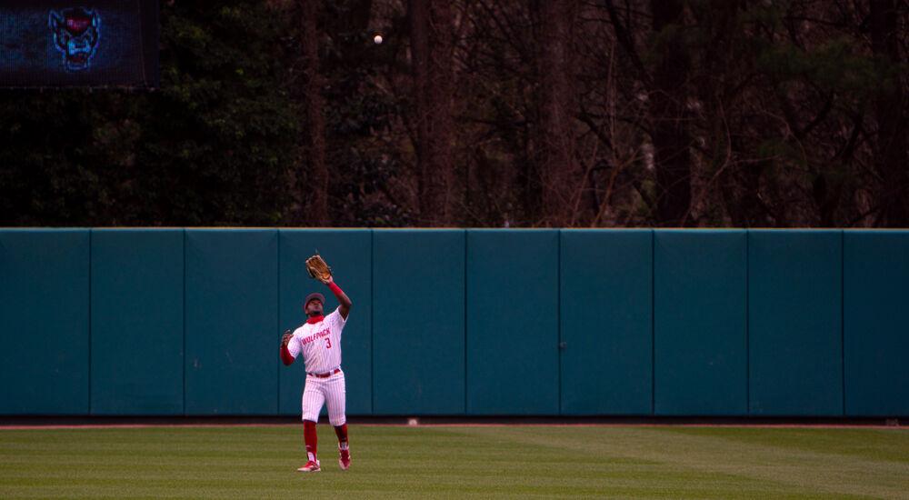 Junior outfielder Devonte Brown catches a fly ball against Louisville on Saturday, March 20, 2021 at Doak Field. Brown went 0-4 with a strikeout as the Wolfpack lost 6-3.