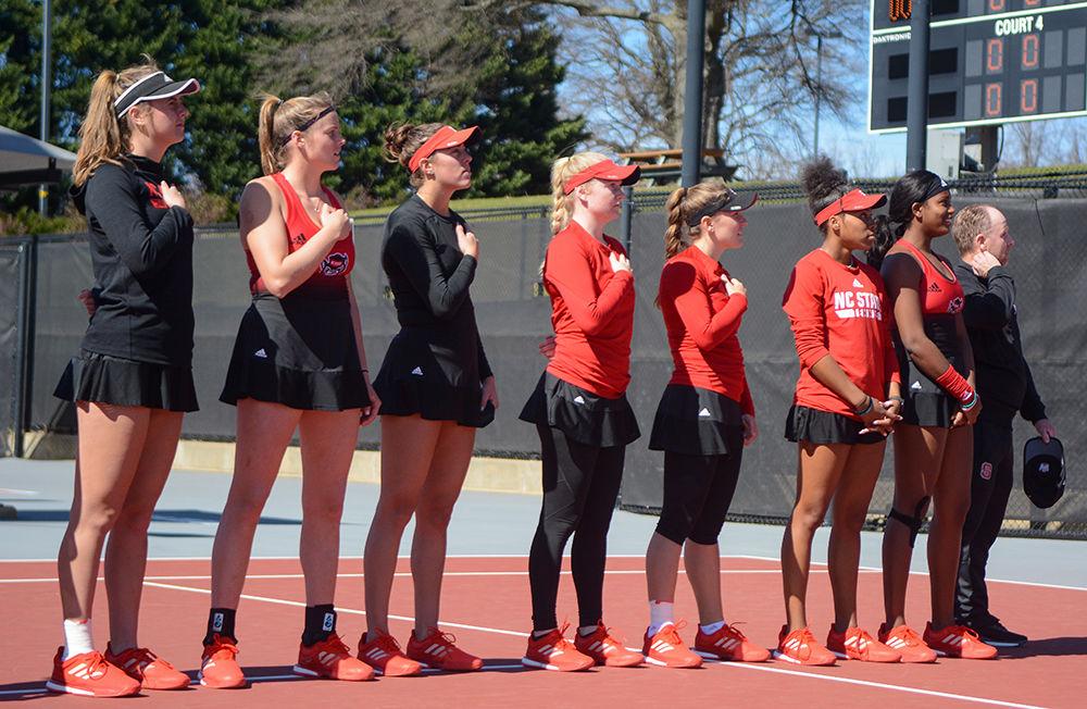 The women's tennis team lines up for the national anthem at the tennis match against Virginia on Sunday, March 1, 2020 at J.W. Isenhour Tennis Center.
