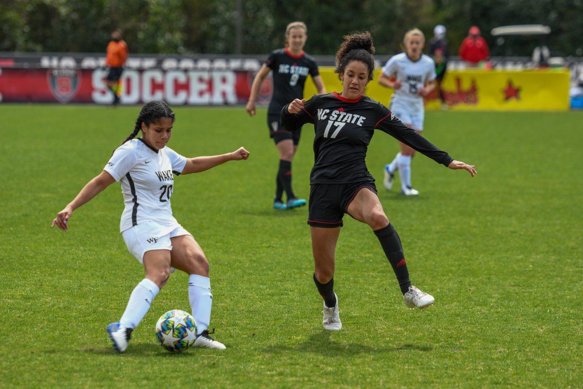 Senior midfielder Mikhail Johnson tries to block a pass during the game versus the Wake Forest Demon Deacons on Saturday, March 20, 2021 in Dail Soccer Park. The Wolfpack lost to the Demon Deacons 1-0 in double overtime.
