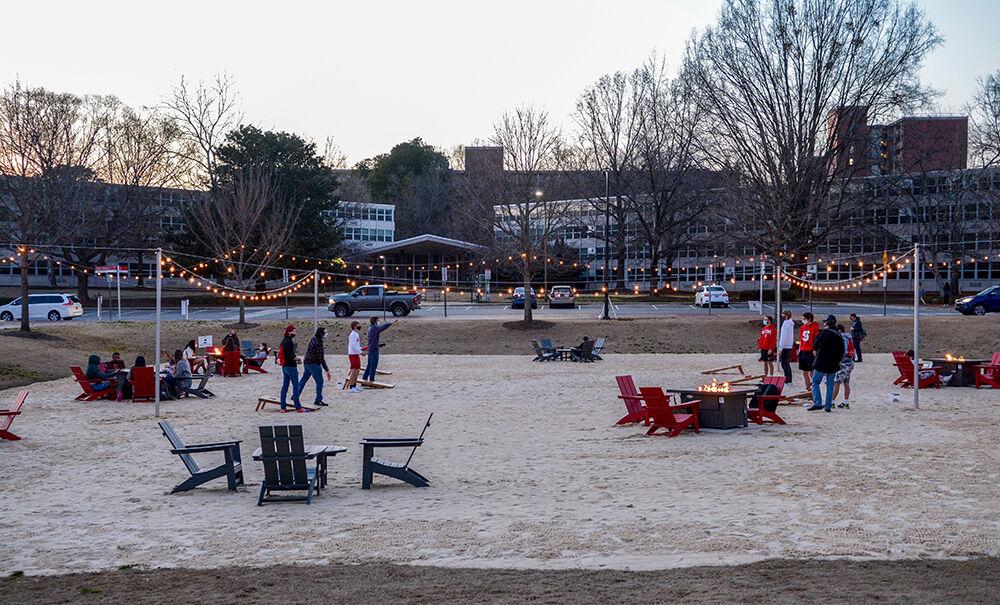 Students play cornhole at The Den on Thursday, March 4, 2021 at Harris Field. The Den was placed on Harris Field to give students an outdoor space to hang out while being socially distanced.