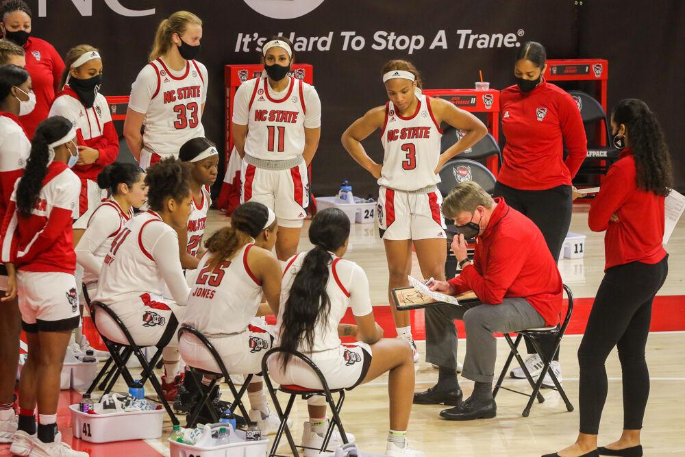 Head coach Wes Moore talks to his team at a timeout while No. 4 NC State women&#8217;s basketball took down Clemson 86-65 on Thursday, Feb. 11, 2021 in Reynolds Coliseum.