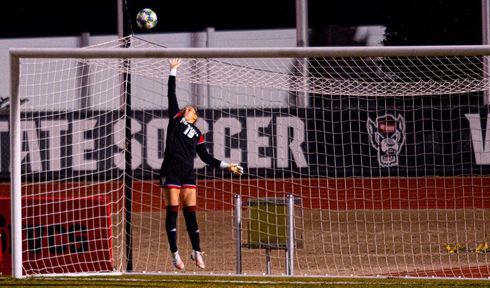 Freshman goalkeeper Maria Echezarreta leaps for the ball on Wednesday, Feb. 10, 2021 at Dail Soccer Field. The Wolfpack won 2-1 in overtime.