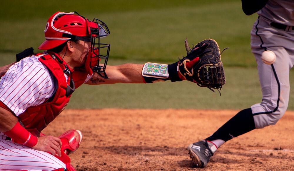 Sophomore catcher Luca Tresh catches a pitch against Louisville on Saturday, March 20, 2021 at Doak Field. Tresh went 1-4 with a strikeout as the Wolfpack lost 6-3.