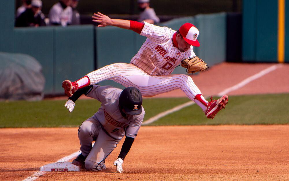 Sophomore infielder Tyler McDonough tries to avoid contact with Louisville infielder Christian Knapczyk on Saturday, March 20, 2021 at Doak Field. McDonough went 0-2 with two walks as the Wolfpack lost 6-3.