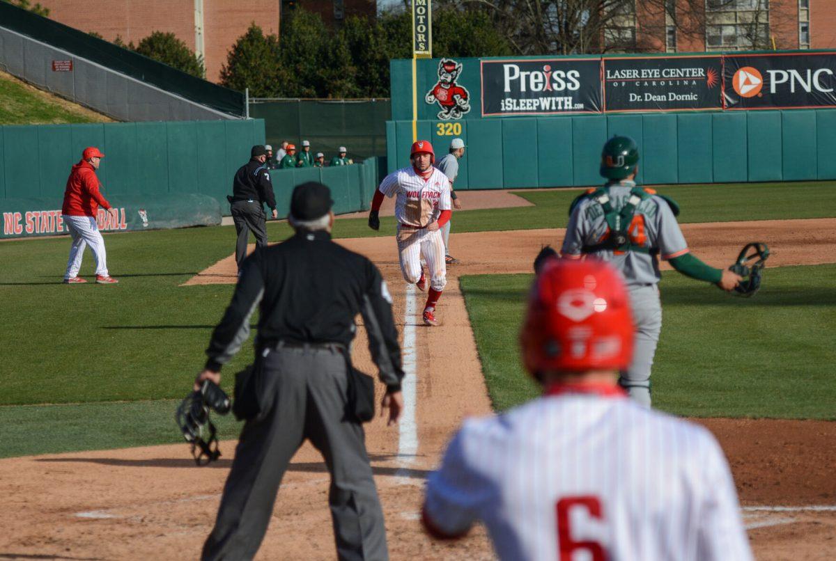 Junior outfielder Jonny Butler runs to home plate for an RBI on Friday, March 5, 2021 at Doak Field. Butler added 2 hits alongside his run scored during the Wolfpack&#8217;s 11-5 win over the Miami Hurricanes.