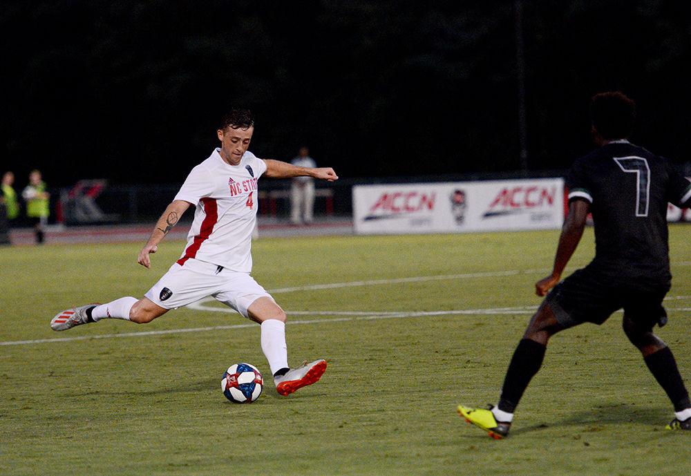 Junior defender David Norris kicks the ball down the field during the game against Loyola on Friday, August 30, 2019. The team had a collective total of 17 shots on goal. The Wolfpack beat Loyola 2-1.
