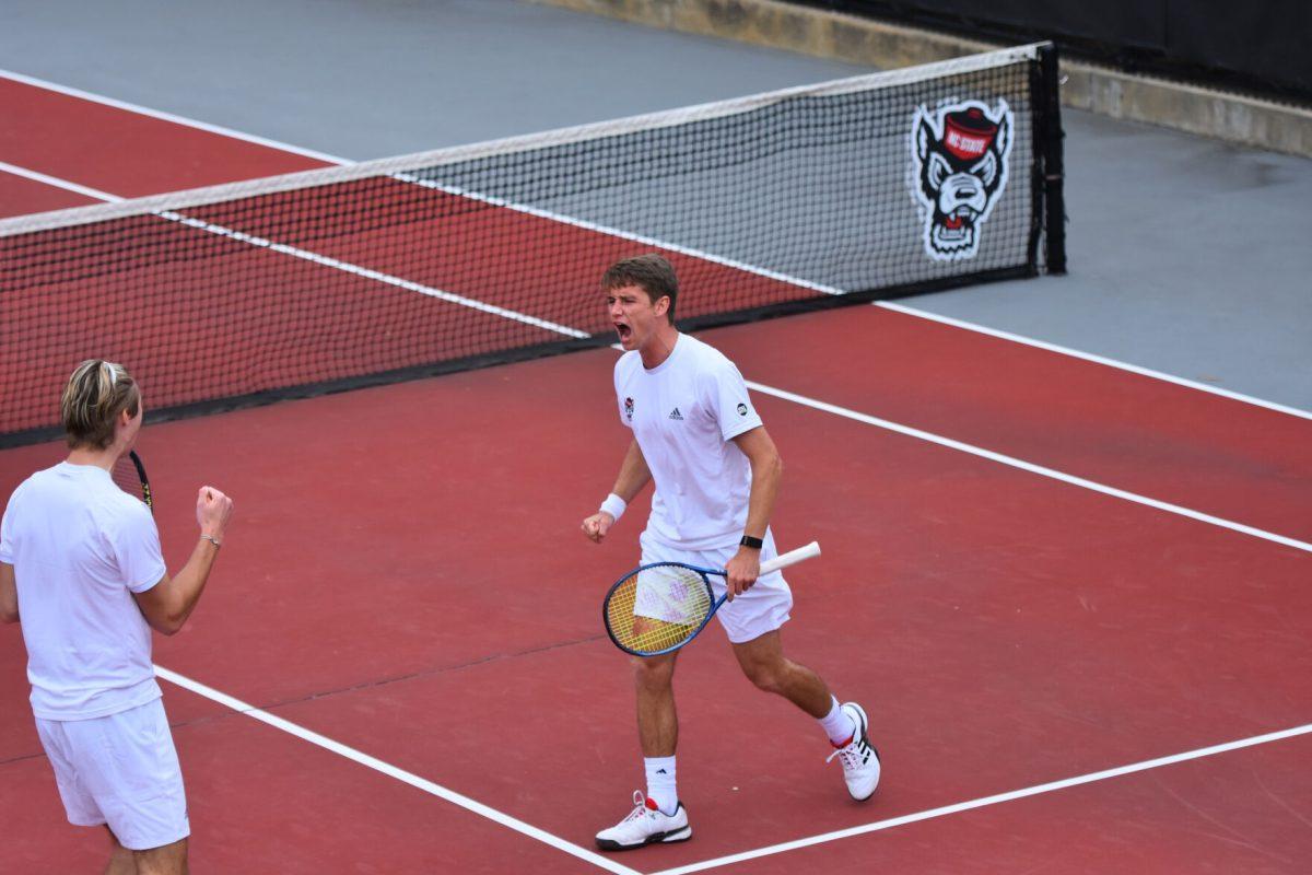 Senior Collin Shick celebrates with partner Robin Catry Saturday, March 13, 2021 at J.W. Isenhour Tennis Center. The pair won their doubles match six games to two during the Wolfpack&#8217;s 4-1 team win over the Miami Hurricanes.