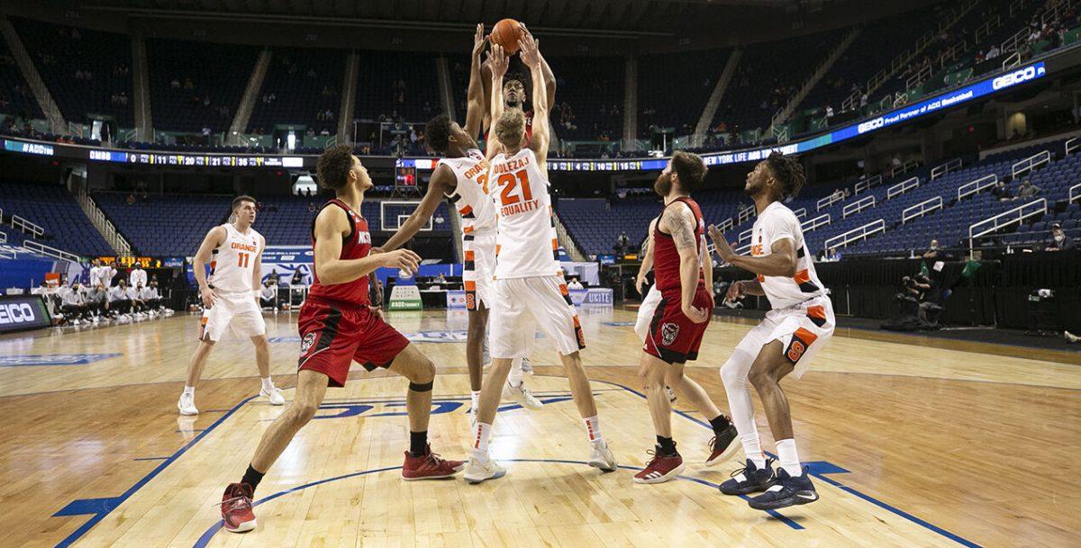 N.C. State&#8217;s Manny Bates (15) puts up a shot against the Syracuse zone defense during the second half on Wednesday, March 10, 2021 during the ACC Tournament at the Greensboro Coliseum in Greensboro, N.C.