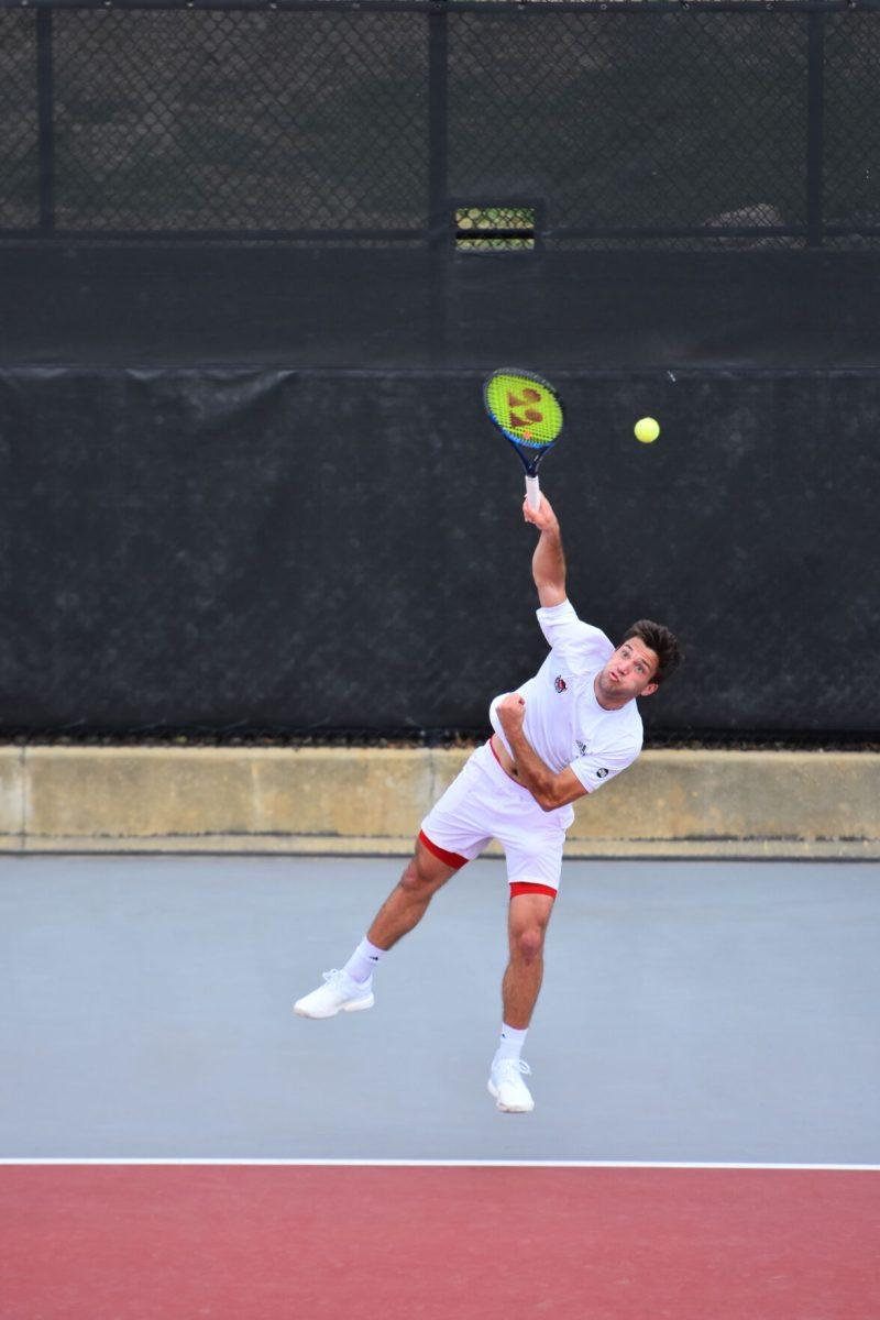 Fifth year Alexis Galarneau serves during a game on Saturday, March 13, 2021 at J.W. Isenhour Tennis Center. Galarneau won his individual match 2-1 during the Wolfpack&#8217;s 4-1 team win over the Miami Hurricanes.