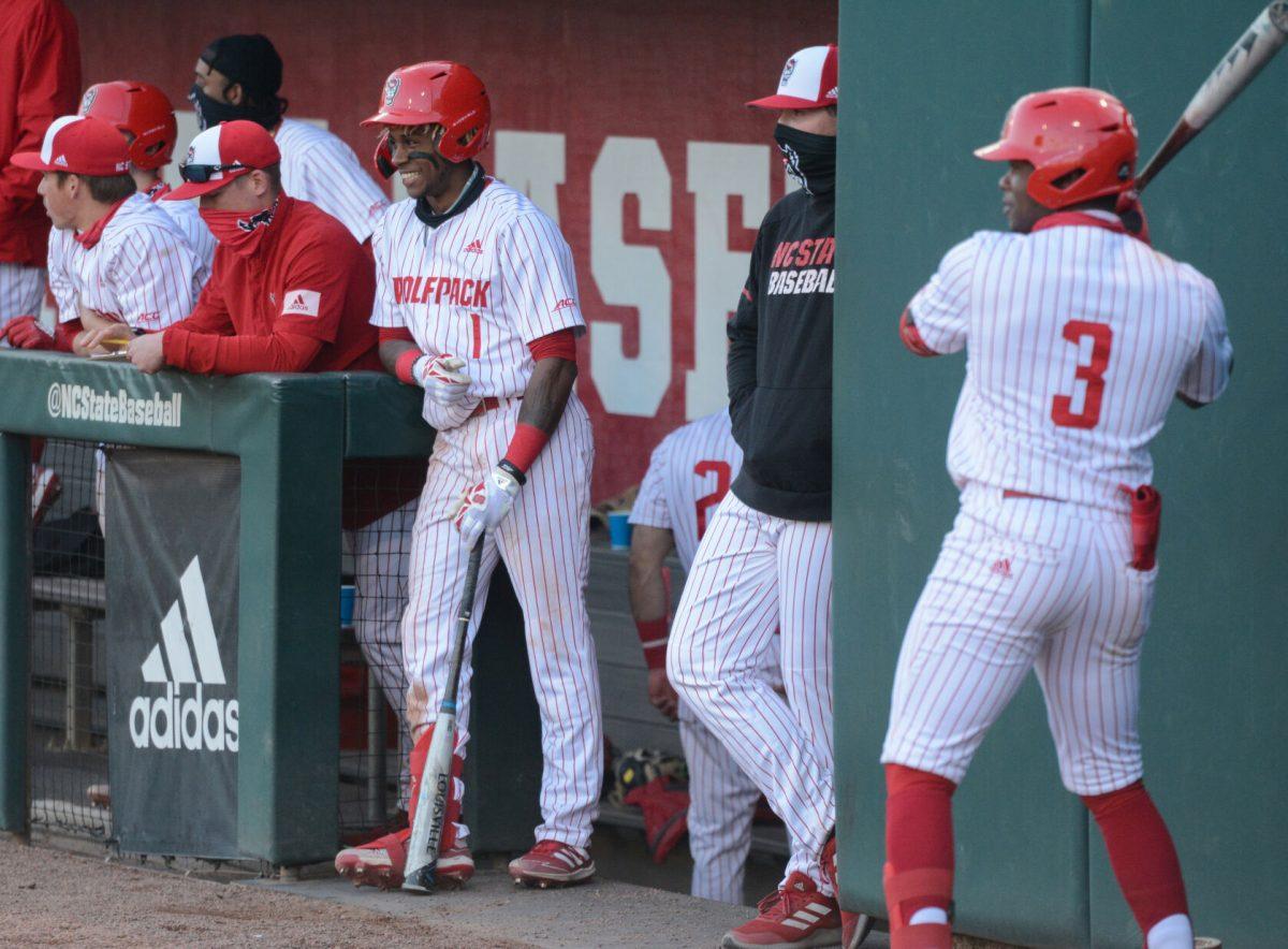 Junior outfielder Tarrell Tatum smiles in the dugout alongside his teammates in the Wolfpack&#8217;s 11-5 win over the Miami Hurricanes on Friday, March 5, 2021 at Doak Field.
