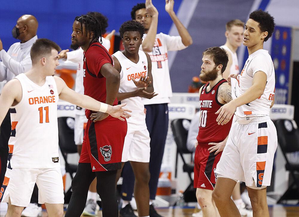 N.C. State seniors D.J. Funderburk (0), left, and Braxton Beverly (10) start to walk off the floor after Syracuse&#8217;s 89-68 victory over N.C. State in the second round of the ACC Men&#8217;s Basketball Tournament in Greensboro, N.C., Wednesday, March 10, 2021.