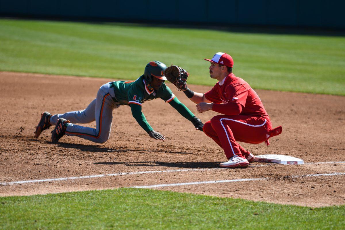 Junior infielder Austin Murr looks to tag out a runner during the game versus the Miami Hurricanes on Sunday, March 7, 2021 in Doak Field at Dail Park. The Hurricanes beat the Wolfpack 6-4.
