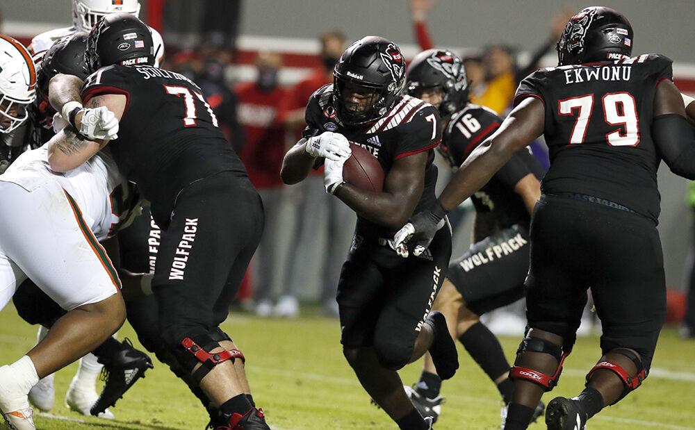 N.C. State running back Zonovan 'Bam' Knight (7) scores on a one-yard touchdown run without his shoe during the second half of Miami&#8217;s 44-41 victory over N.C. State at Carter-Finley Stadium in Raleigh, N.C., Friday, Nov. 6, 2020.