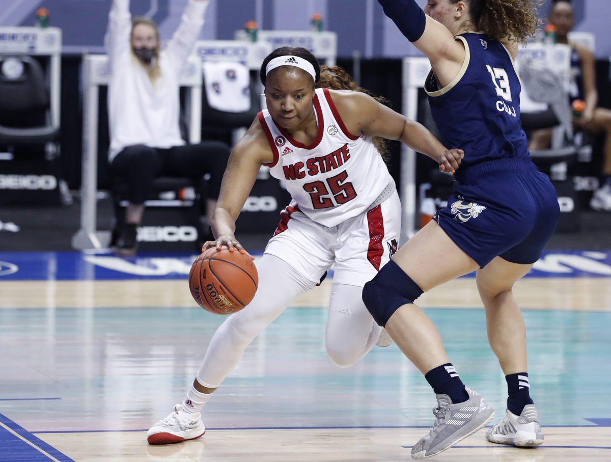 N.C. State's Kayla Jones (25) drives around Georgia Tech's Lorela Cubaj (13) during the first half of N.C. State&#8217;s game against Georgia Tech in the semifinals of the ACC Women&#8217;s Basketball Tournament in Greensboro, N.C., Saturday, March 6, 2021.