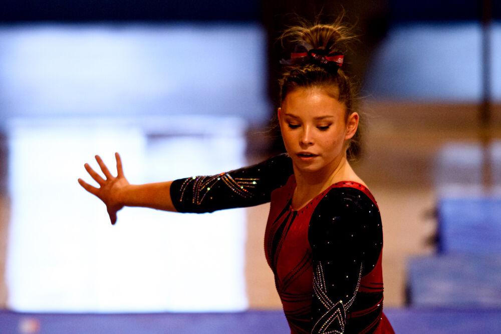 Senior Katie Cox performs on the balance beam on Saturday, March 13, 2021 at Reynolds Coliseum. Cox scored a 9.675 in the event. The Wolfpack beat Long Island University with a team score of 196.900.