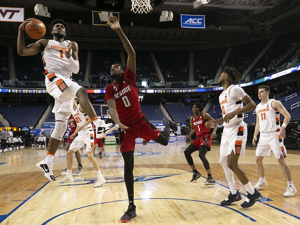 Syracuse&#8217;s Quincy Guerrier (1) secures a defensive rebound over N.C. State&#8217;s D J Funderburk (0) (10) during the second half on Wednesday, March 10, 2021 during the ACC Tournament at the Greensboro Coliseum in Greensboro, N.C.
