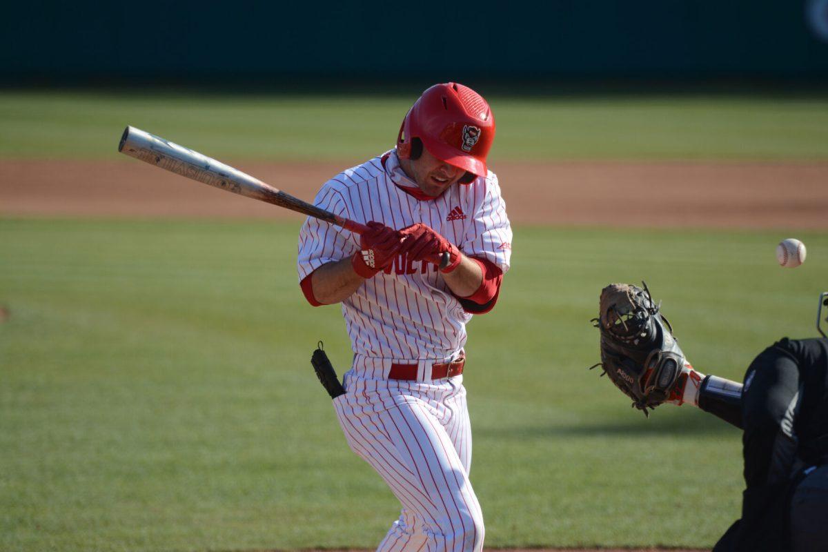 Junior infielder J.T. Jarrett reacts after being hit by a pitch on Friday, March 5, 2021 at Doak Field. Jarrett added 1 RBI during the Wolfpack&#8217;s 11-5 win over the Miami Hurricanes.