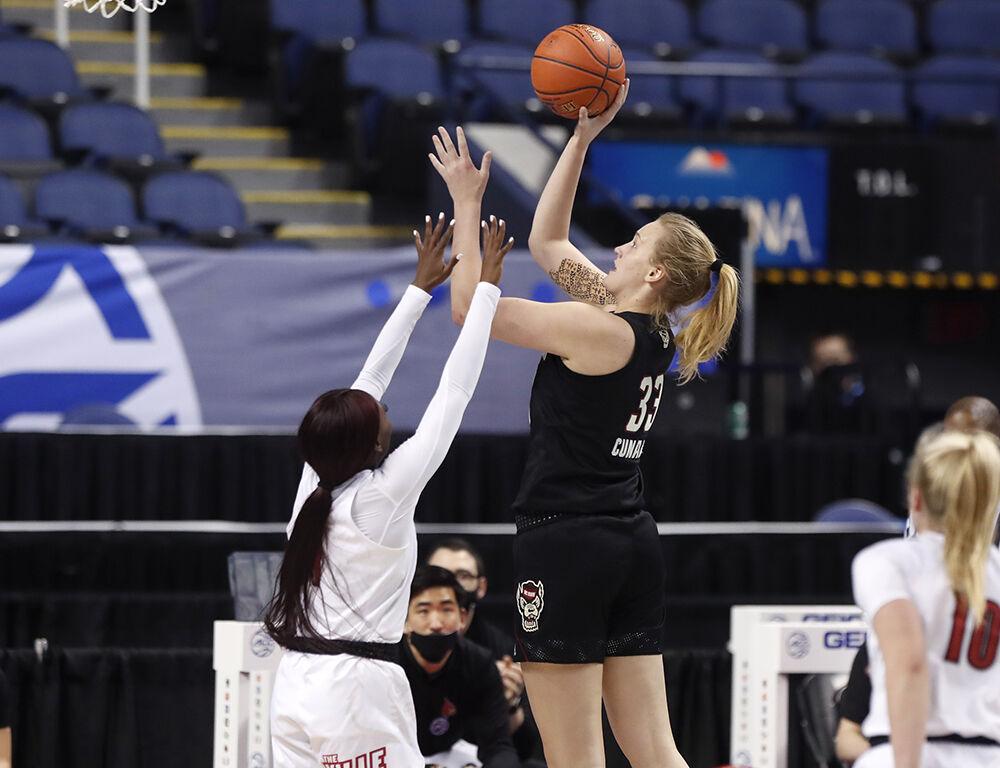 N.C. State's Elissa Cunane (33) shoots as Louisville's Dana Evans (1) defends during first half of N.C. State&#8217;s game with Louisville in the finals of the ACC Women&#8217;s Basketball Tournament in Greensboro, N.C., Sunday, March 7, 2021.