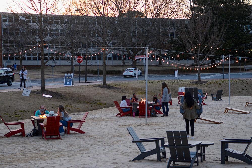 Students relax at The Den on Thursday, March 4, 2021 at Harris Field. The Den is a temporary outdoor space in which students can take time with friends while being socially distanced.
