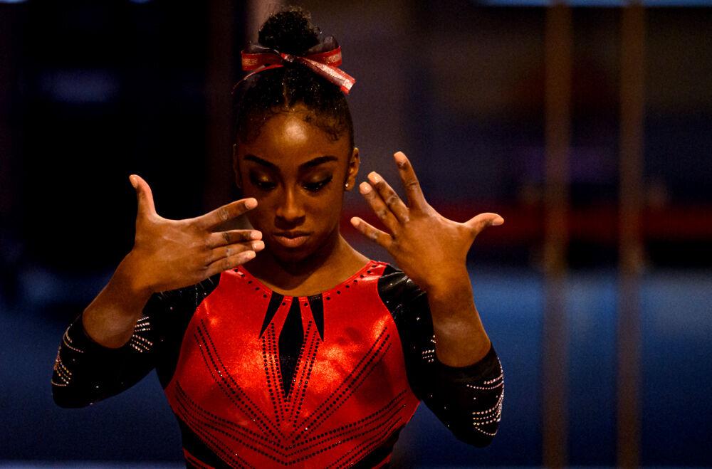 Freshman Madison Benson performs on the balance beam on Saturday, March 13, 2021 at Reynolds Coliseum. The Wolfpack beat Long Island University with a team score of 196.900.