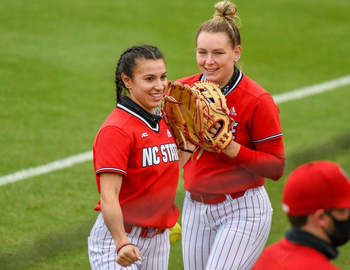 Redshirt senior outfielder Angie Rizzi and redshirt senior outfielder Brigette Nordberg smile before the matchup against Louisiana State Universtiy on Saturday, April 18, 2021 in Dail Softball Stadium. The Wolfpack lost to the Tigers 2-1.