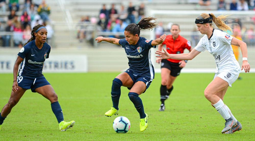 NC Courage midfielder Debinha sends a back heel pass to forward Crystal Dunn on Sunday, Oct. 20 at WakeMed Soccer Park. Debinha scored one goal as the Courage won 4-1 to advance to the NWSL championship final.