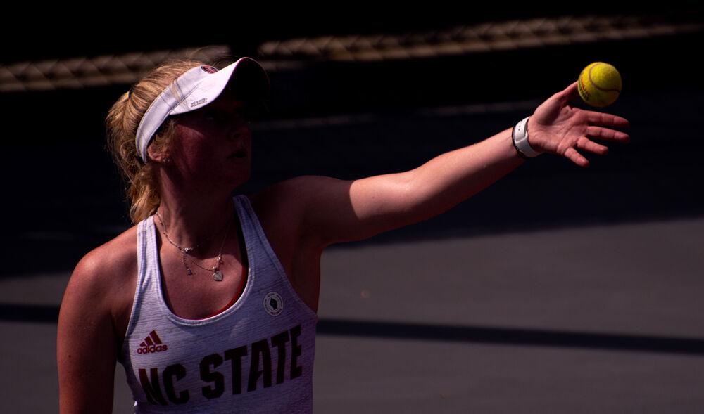 Senior Lexi Keberle serves against No. 12 Virginia on Sunday, April 11, 2021 at J.W. Isenhour Tennis Center. Keberle won the deciding singles match 7-5, 5-7, 6-4 to help the No. 6 Wolfpack to a 4-3 win.