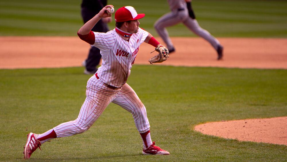 Sophomore infielder Tyler McDonough throws to first base against Louisville on Saturday, March 20, 2021 at Doak Field. The Wolfpack lost 6-3.