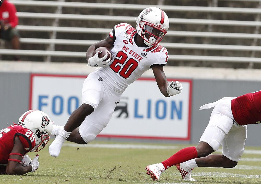 N.C. State wide receiver Julian Gray (20) is tackled after a long reception during the first half of N.C. State football&#8217;s spring game at Carter-Finley Stadium in Raleigh, N.C., Saturday, April 10, 2021.