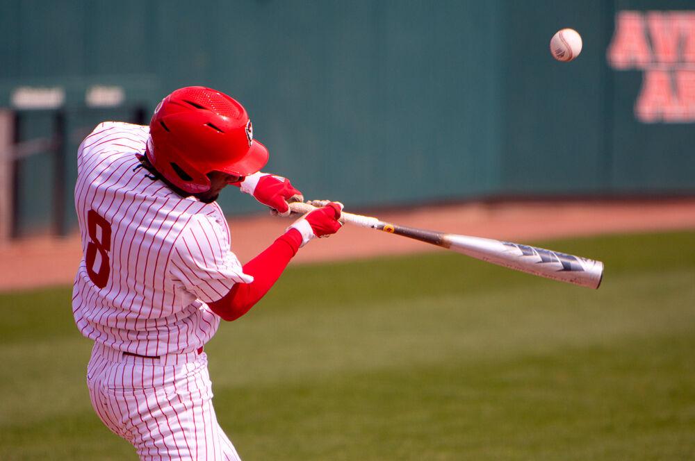 Freshman infielder Jose Torres makes contact against Louisville on Saturday, March 20, 2021 at Doak Field. Torres went 2-4 with a home run, a triple and two runs batted in as the Wolfpack lost 6-3.