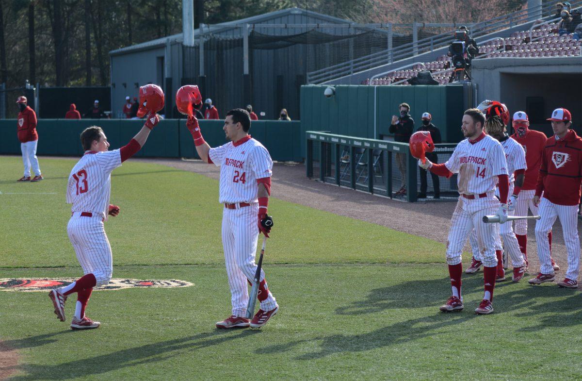 Sophomore center fielder Tyler McDonough celebrates with his teammates after hitting a solo home run on Friday, March 5, 2021 at Doak Field. McDonough&#8217;s 2 hits scored 3 runs for the Wolfpack in their 11-5 win over the Miami Hurricanes.