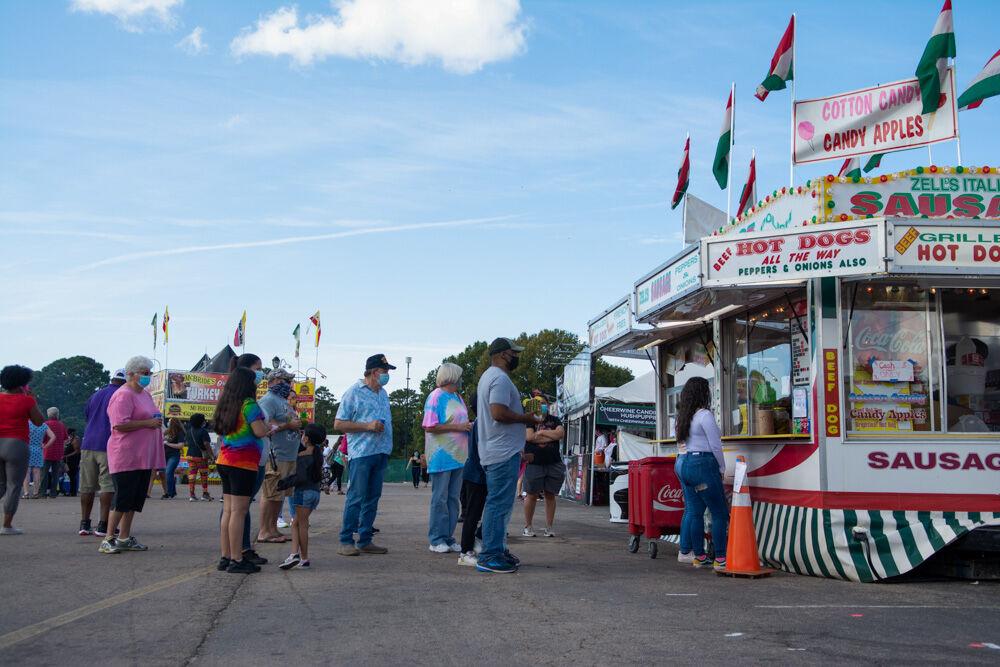 People wait in line for cotton candy, hot dogs, and candy apples at the NC State Fair Food days event on Wednesday, Oct. 21. 2020. The NC State Fair was cancelled for the year of 2020, but food vendors were featured at the fairgrounds for 10 days.