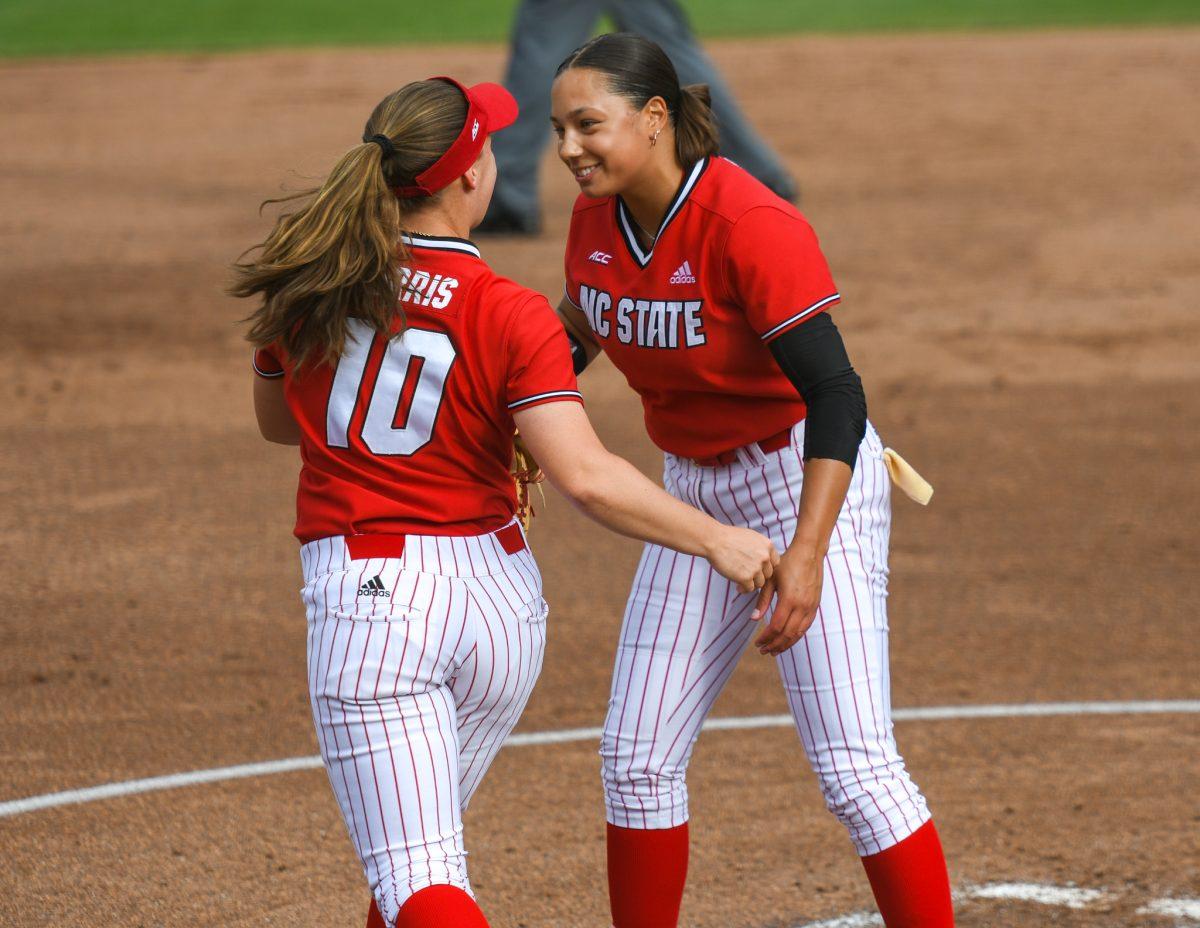Redshirt junior infielder Logan Morris celebrates with freshman pitcher Estelle Czech after Morris tagged out a Louisiana State Universtiy runner on Saturday, April 18, 2021 in Dail Softball Stadium. The Wolfpack lost to the Tigers 2-1.