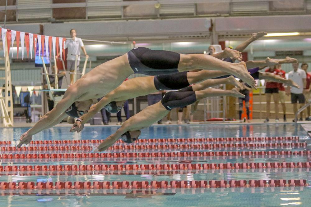 Members of the men's swimming team jump off the starting blocks for the hypoxic challenge, a 50-yard underwater kick on Friday, Sept. 28 In the Casey Aquatic Center. This was one of many events held at the fourth annual Wolfpack Games.